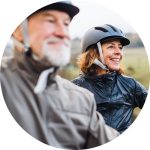 Man and woman wearing helmets outside circle
